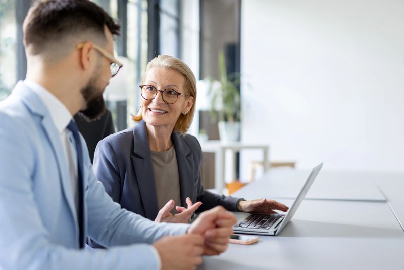An engaging conversation takes place among professionals, illustrating teamwork and the essence of business discussions in a contemporary office.