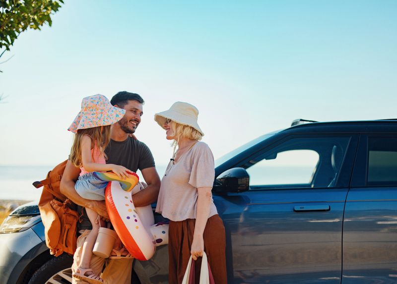 A cheerful family gathers near their car beside the sea, ready for a fun vacation. The sun shines brightly as they prepare with beach gear, symbolizing carefree summer days filled with joy.