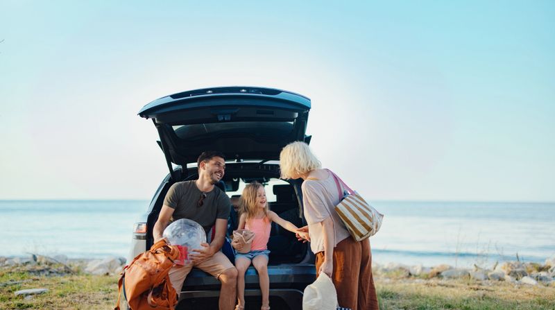 A cheerful family enjoys their vacation by the ocean, spending quality time together in summer's warm embrace, showcasing joy, togetherness, and the essence of beach celebrations.