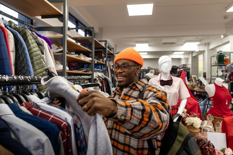 A shopper browses clothes in a local charity shop, embracing sustainable shopping by giving pre-loved items a new life. Surrounded by second-hand goods, the moment highlights mindful consumption and community support.

Videos are available similar to this scenario.