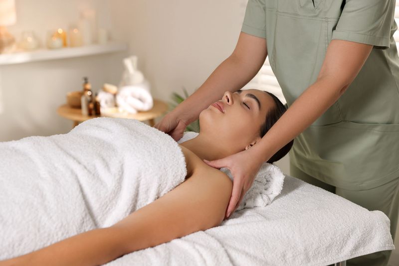 Young woman receiving massage in spa salon