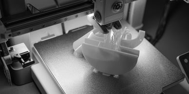 3D printer creating a model in black and white.