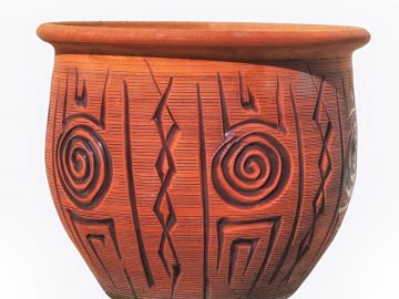 Decorative terracotta pot with intricate patterns.