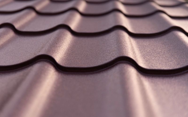 Elegant metal roof tiles glisten under soft sunlight