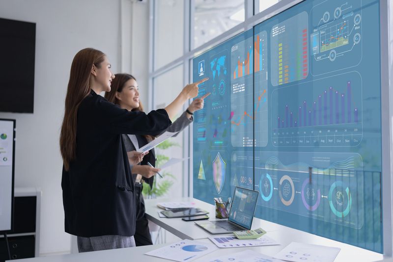 Two businesswoman presentation with marketing strategy analysis at meeting room, Business technology in boardroom for training marketing concept.