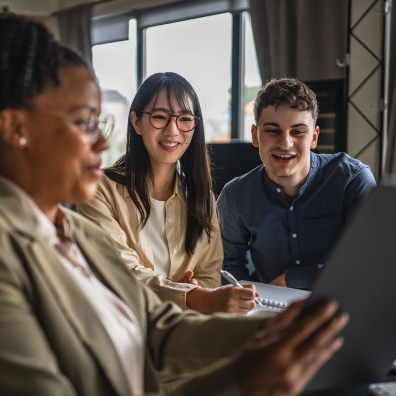african american financial adviser show finance plan to young entrepreneurs, highlighting teamwork and communication