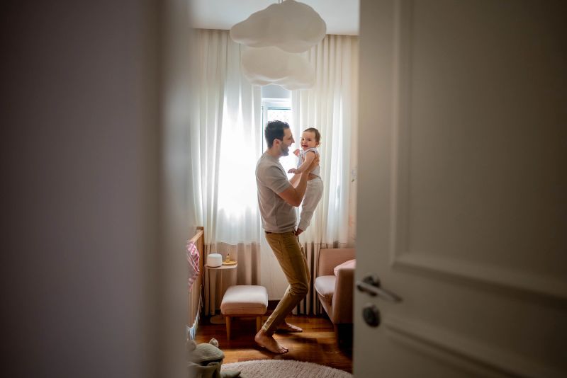 Father playing with his daughter at home
