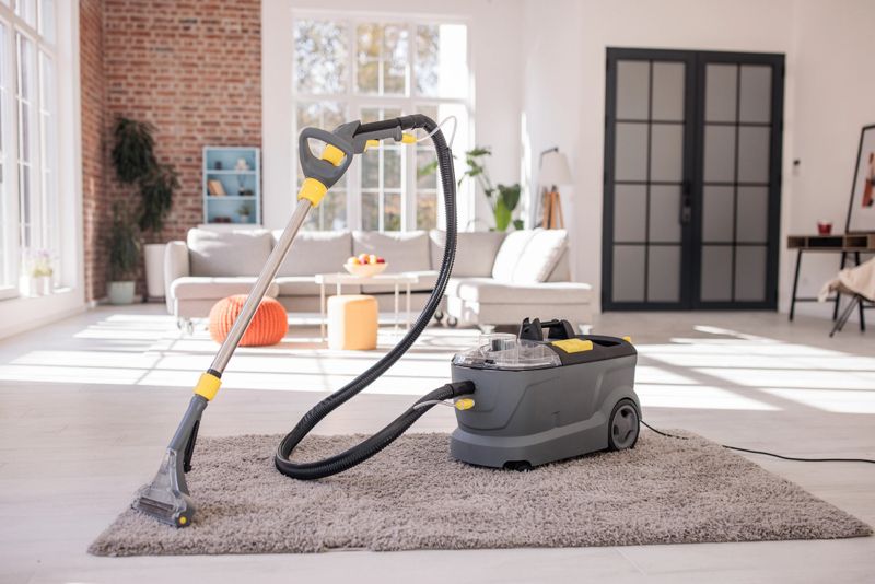 Powerful deep-wash vacuum cleaner positioned in the center of a tidy, modern apartment.