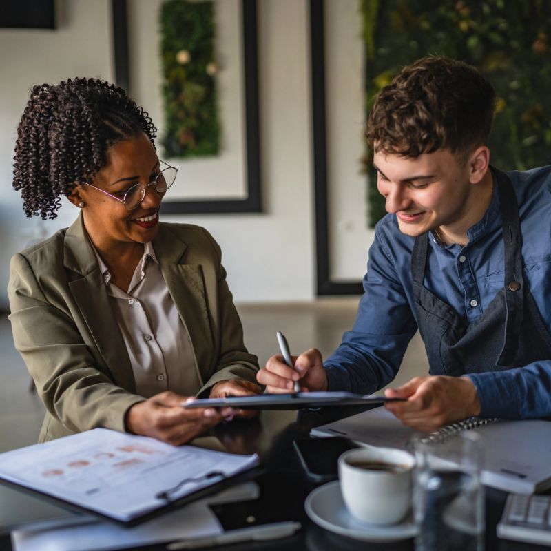young man entrepreneur sing contract with african american female financial