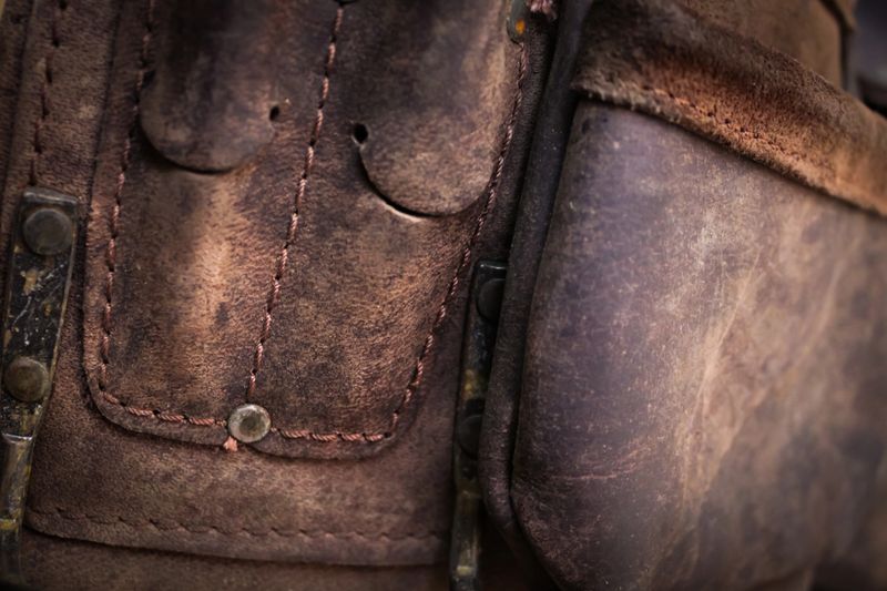 macro photo of stitching and patina on vintage leather texture background