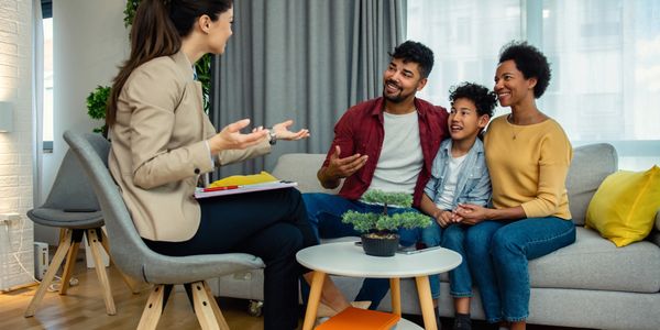 A family consulting with a professional in a cozy living room.