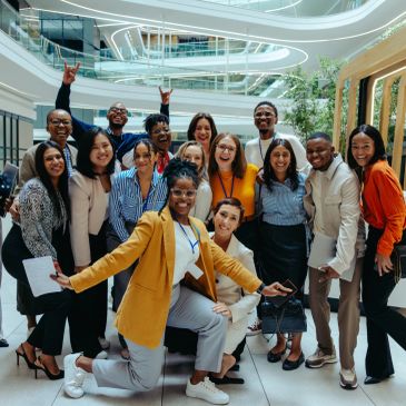 Happy diverse group of coworkers posing in a modern office.