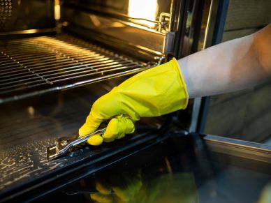 Person cleaning oven