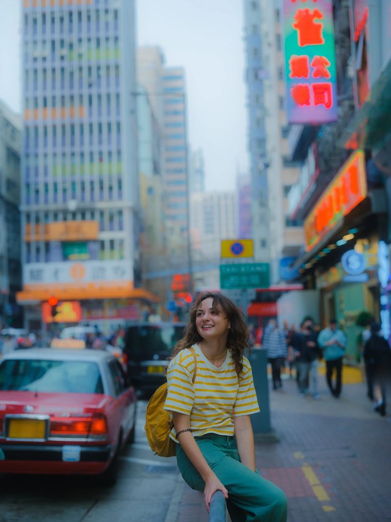 Serene woman walking in neon lit Kowloon City during experiential urban exploration in  Hong Kong