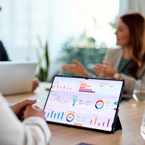 Tablet displaying business charts during a meeting.