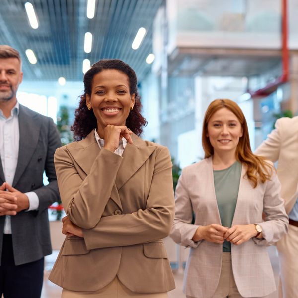 Confident diverse professionals smiling in a modern office.