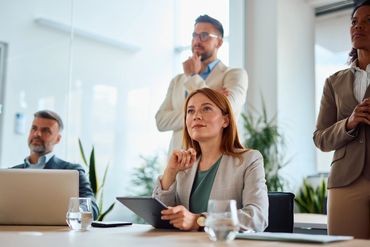 Business team attentively listens during a meeting in a modern office.