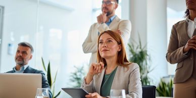 Focused businesswoman listening in a meeting.