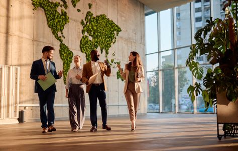 A man and two women looking at something on the laptop.