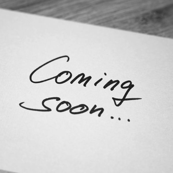 A note with 'Coming soon...' written on it in black ink.