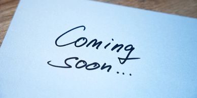 A note with 'Coming soon...' written on it in black ink.