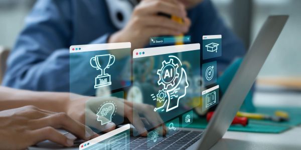 Person using laptop with AI and education icons.