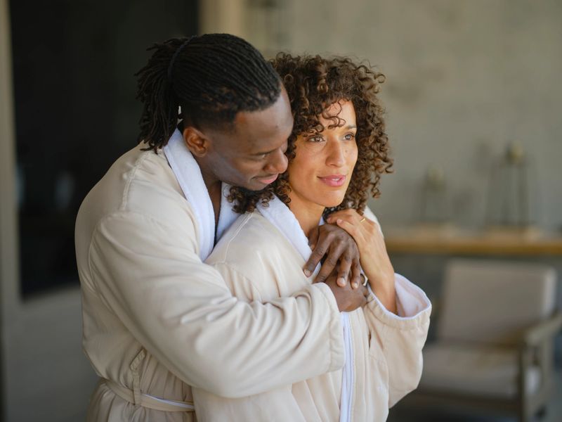 A young couple wearing robes, relaxing at a luxury resort hotel spa.