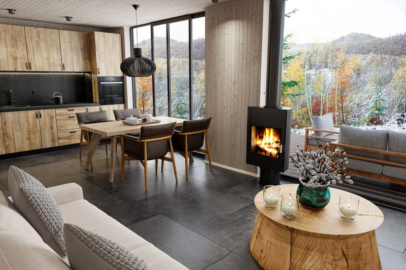 A cozy and refined Scandinavian open-plan interior combining kitchen, dining, and living spaces in natural harmony. The rustic oak kitchen with black stone floor tiles seamlessly flows into the living room, where a freestanding modern metal fireplace radiates warmth beside floor-to-ceiling windows overlooking snowy mountains. The space is wrapped in light pine wood paneling and features a striking round coffee table crafted from a solid tree trunk, adding a raw, sculptural touch. A minimalist dining area with a large wooden table and leather-accented chairs completes the inviting, nature-inspired atmosphere. Ideal for promoting sustainable design, mountain retreats, Scandinavian aesthetics, interior architecture, eco homes, and cabin living. Log cabin.