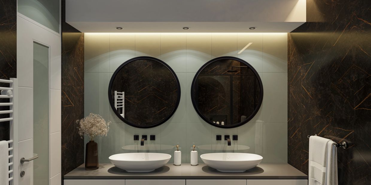 Modern bathroom with double sinks, round mirrors, and elegant dark marble walls.