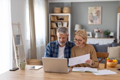 Mature couple working together at a laptop.