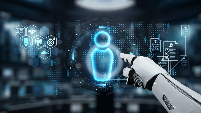 A robotic hand reaching out to a glowing holographic figure in a high-tech environment, symbolizing the convergence of technology, innovation, and data interaction. Auvana