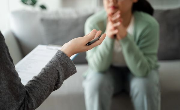 A person listens attentively during a counselling session.