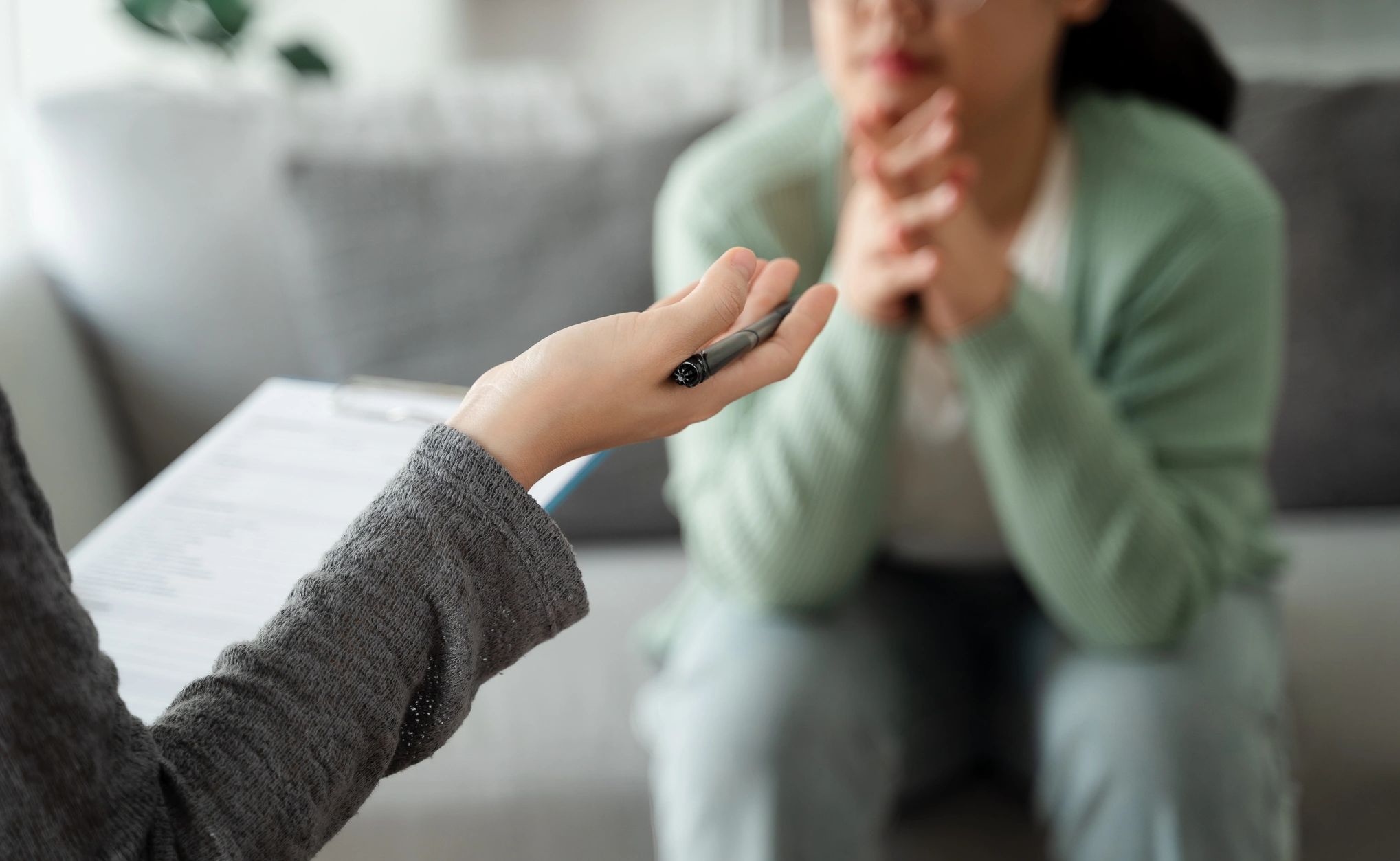 A person attentively listening during a therapy session.