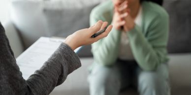 A therapist listens attentively to a patient during a counseling session.