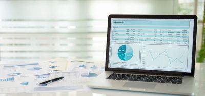 Laptop displaying financial data with charts and graphs.