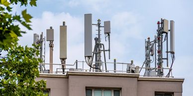 Rooftop cell tower installation with multiple 5G antennas and supporting equipment