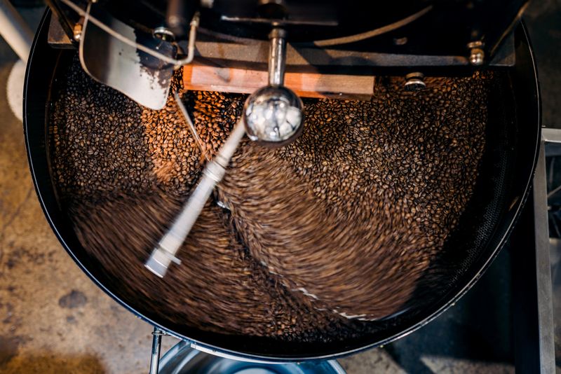 A large coffee roasting machine cools off a fresh batch of single origin organic coffee following the roast phase.  Long exposure with blurred motion.  Shot in Portland, Oregon, USA.
