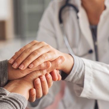 Doctor comforting patient with hand touch.