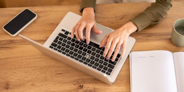 Virtual assistant typing on a laptop