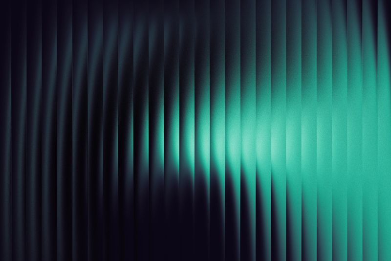 A dynamic gradient display featuring white to green hues against a black background. Vertical lines create a sense of depth and movement with smooth transitions. The glossy texture enhances the visual clarity, portraying a modern and sleek design reminiscent of glass. The interplay of light and dark provides a technological and fresh aesthetic.