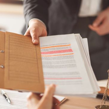 Person handing over a folder with highlighted documents.