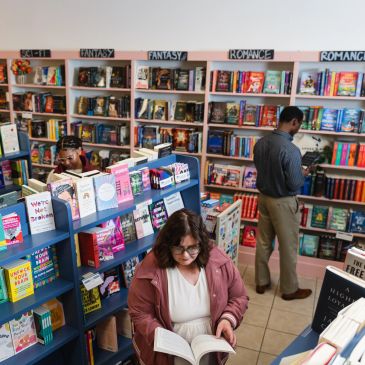 Two people browsing books in a bookstore.