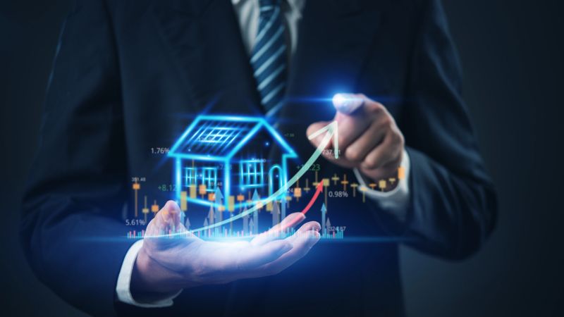 Real estate investment concept with businessman showing housing growth, property analytics, financial chart, and market trends for smart home investment.