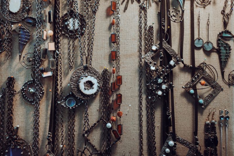A collection of handmade jewelry on a board.