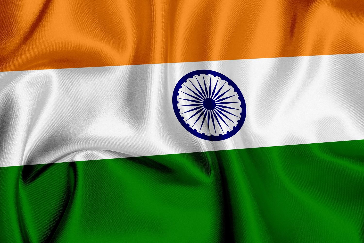 Waving Indian national flag with saffron, white, and green colors and Ashoka Chakra.