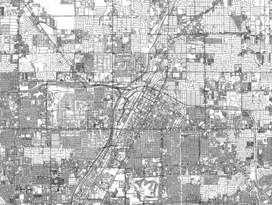 Empty commercial storefronts with brick and stone facades under a blue sky.