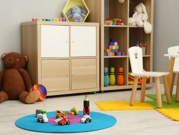 Children's playroom with toys and furniture.
