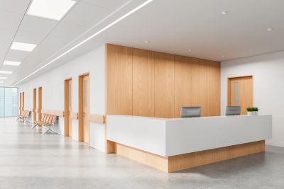 Modern reception desk in a bright, minimalist office hallway.