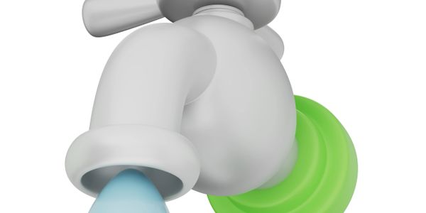 A white faucet with water flowing and a green plunger.