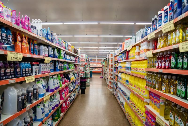 Organized rows of food products stocked in supermarket store. Wide range of groceries displayed in organized rows on shelves in a contemporary grocery store.